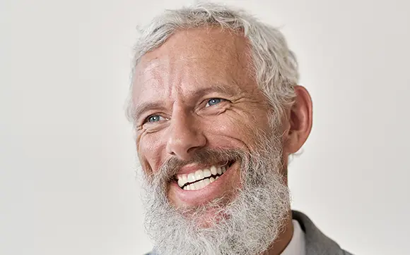 Good Looking Middle Aged Man Smiling With His Dentures 1